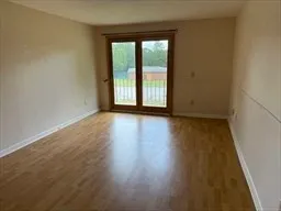 a view of wooden floor and windows in a room