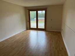 176 Maple Avenue, Unit 3 25 Rutland, MA 01543 - Photo 6 of 16 a view of wooden floor and windows in a room