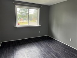 176 Maple Avenue, Unit 3 25 Rutland, MA 01543 - Photo 8 of 16 an empty room with wooden floor and windows