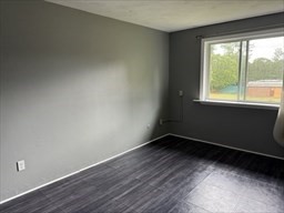 176 Maple Avenue, Unit 3 25 Rutland, MA 01543 - Photo 9 of 16 an empty room with wooden floor and windows