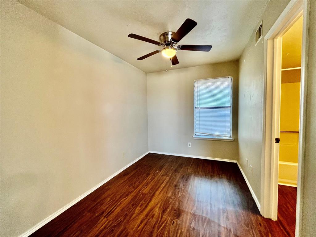 2526 West Prairie Street, Unit 204 Denton, TX 76201 - Photo 5 of 8 a view of empty room with wooden floor and fan