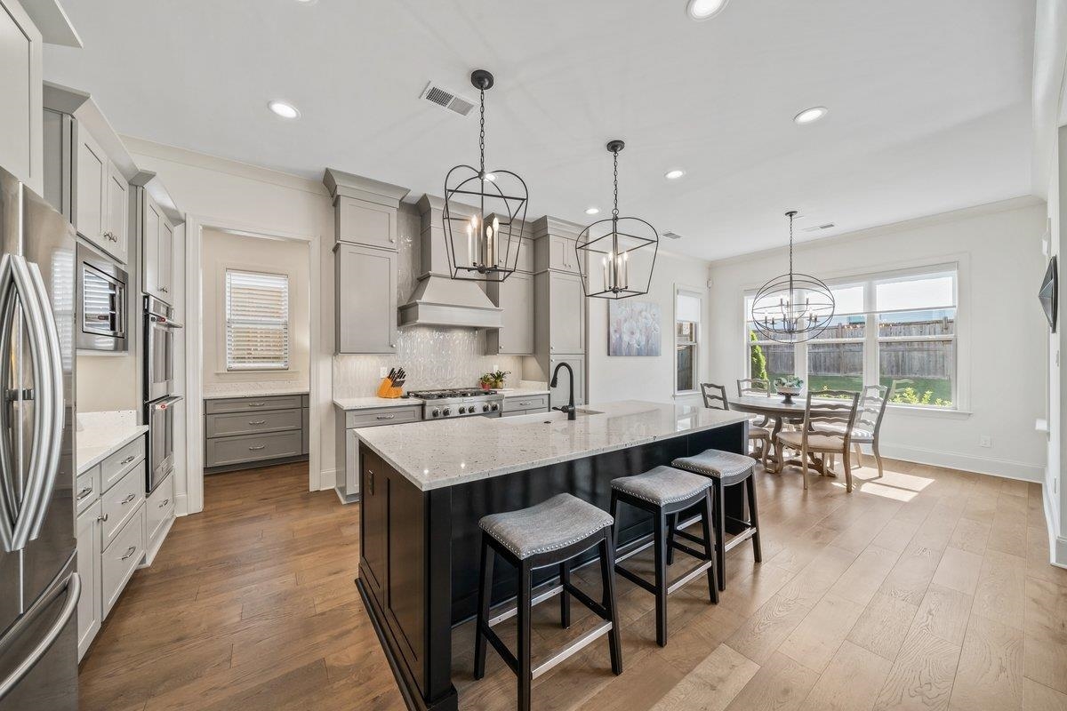 3358 Hidden Bend Lane Collierville, TN 38017 - Photo 12 of 32 a large kitchen with a table and chairs