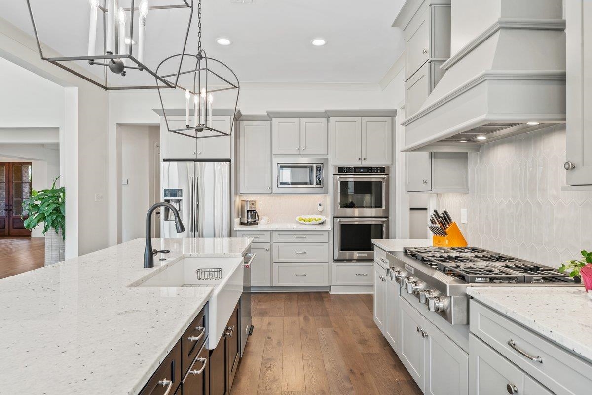3358 Hidden Bend Lane Collierville, TN 38017 - Photo 13 of 32 a kitchen with stainless steel appliances granite countertop a lot of counter space and wooden floors