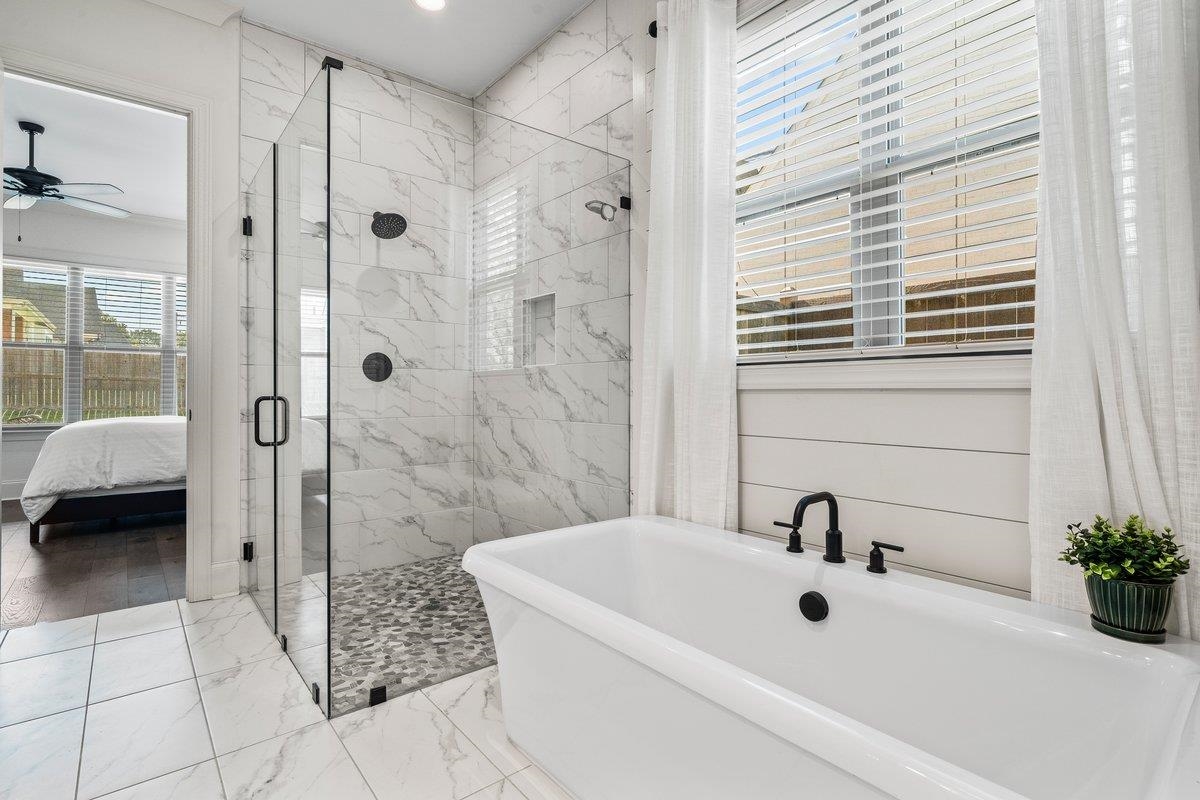 3358 Hidden Bend Lane Collierville, TN 38017 - Photo 21 of 32 a bathroom with a tub a sink and a shower