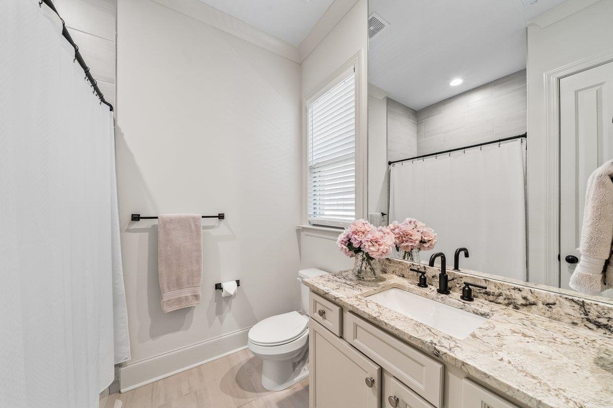 3358 Hidden Bend Lane Collierville, TN 38017 - Photo 23 of 32 a bathroom with a granite countertop sink mirror vanity and toilet