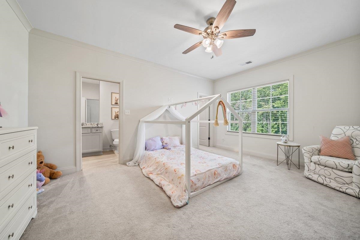 3358 Hidden Bend Lane Collierville, TN 38017 - Photo 25 of 32 a bedroom with a bed and a chandelier