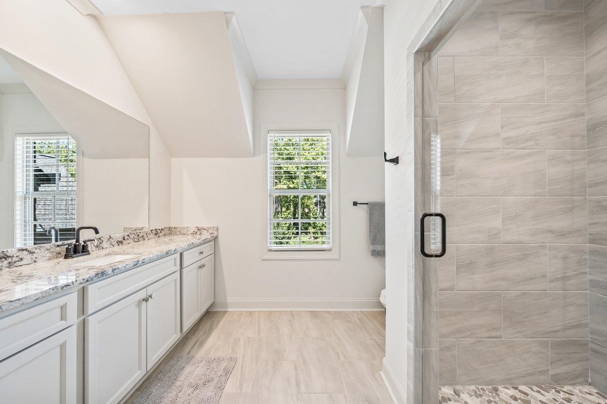 3358 Hidden Bend Lane Collierville, TN 38017 - Photo 28 of 32 a bathroom with a granite countertop sink a shower and a mirror