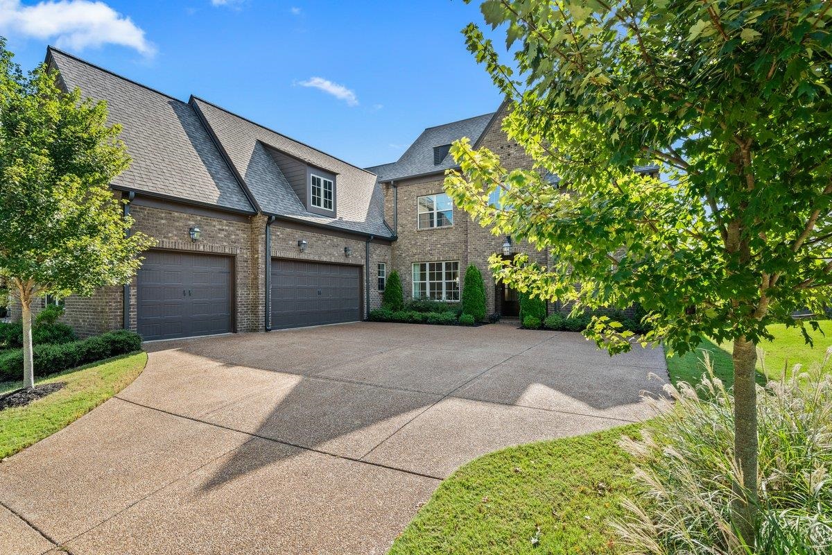 3358 Hidden Bend Lane Collierville, TN 38017 - Photo 3 of 32 a front view of a house with a yard and garage