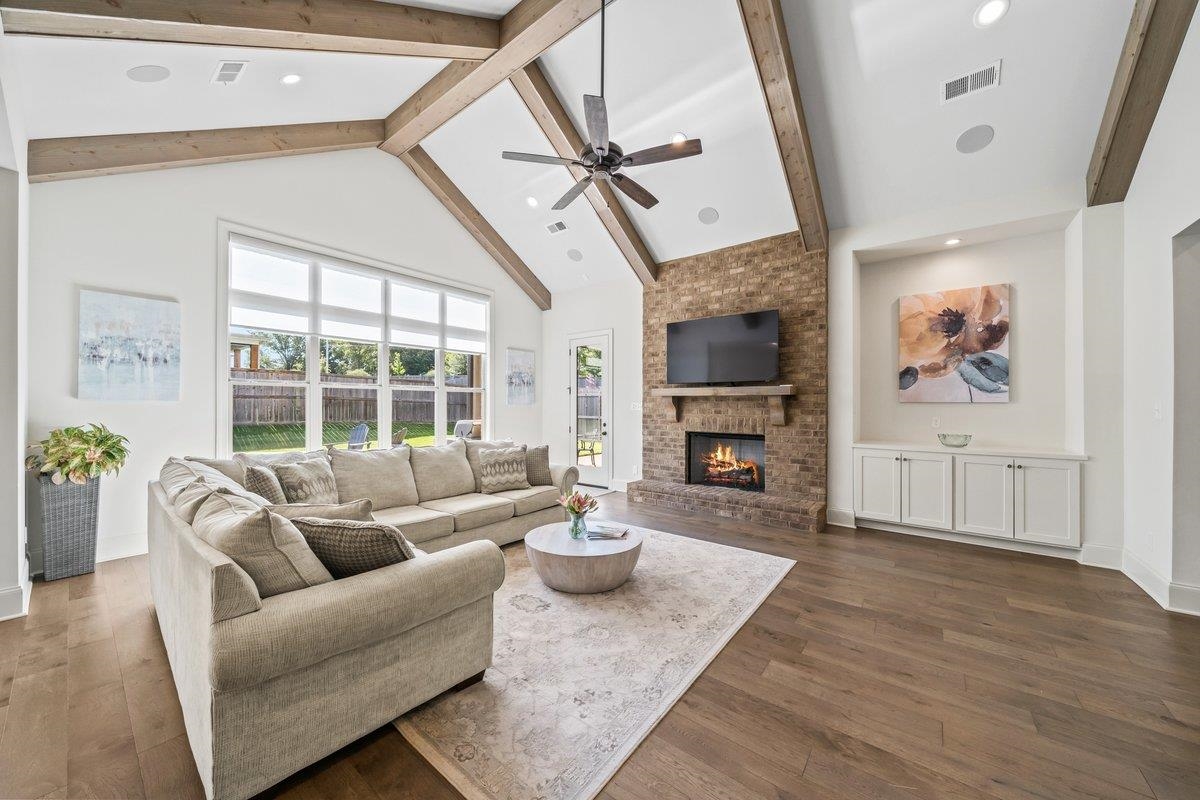 3358 Hidden Bend Lane Collierville, TN 38017 - Photo 9 of 32 a living room with furniture a fireplace and a floor to ceiling window