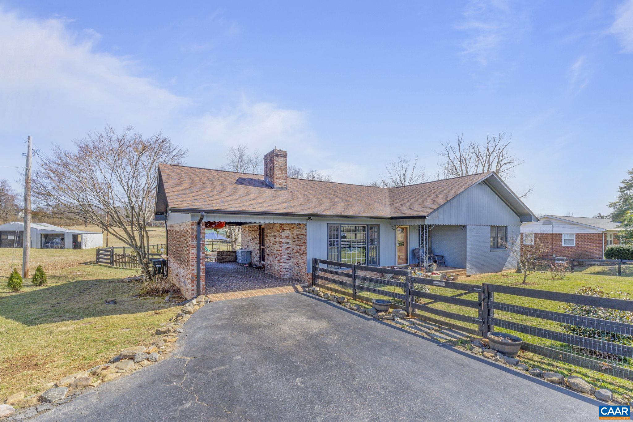 286 Madison Road Stanardsville, VA 22973 - Photo 27 of 48 a view of a house with wooden deck and furniture