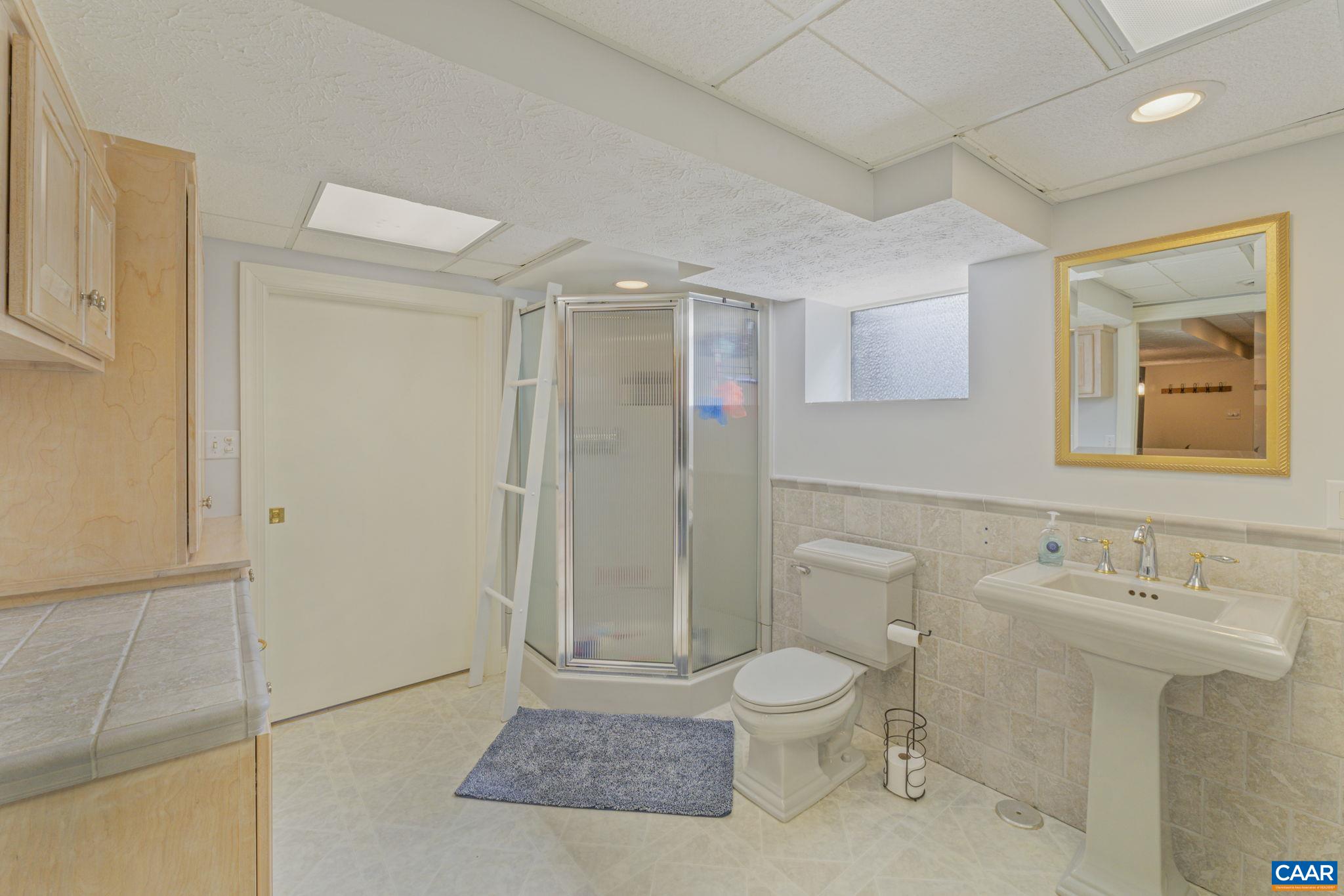 286 Madison Road Stanardsville, VA 22973 - Photo 45 of 48 a bathroom with a toilet sink and shower