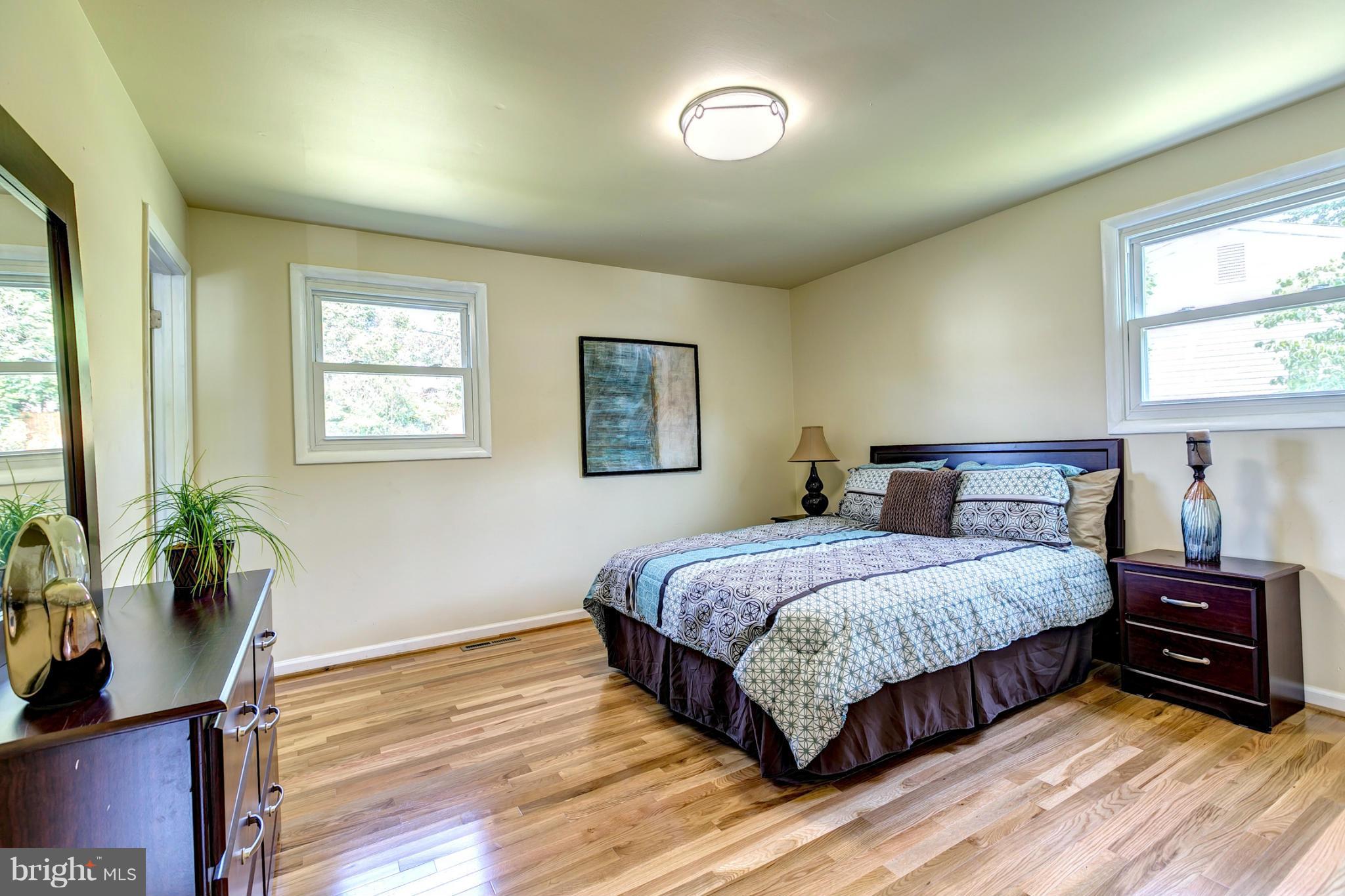 6711 Fox Meadow Road Baltimore, MD 21207 - Photo 13 of 30 a bedroom with a bed and wooden floor