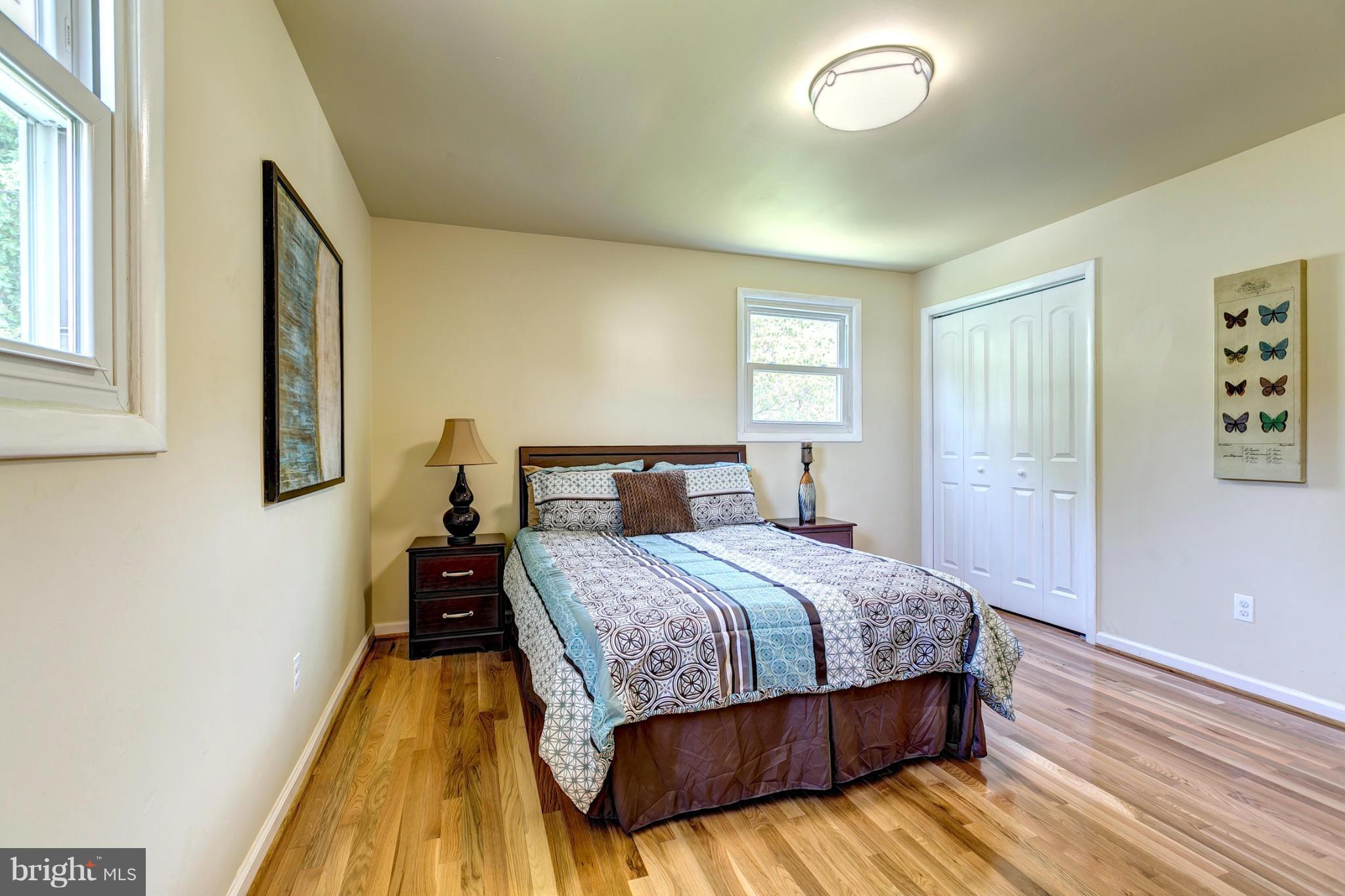 6711 Fox Meadow Road Baltimore, MD 21207 - Photo 14 of 30 a bedroom with a bed and wooden floor