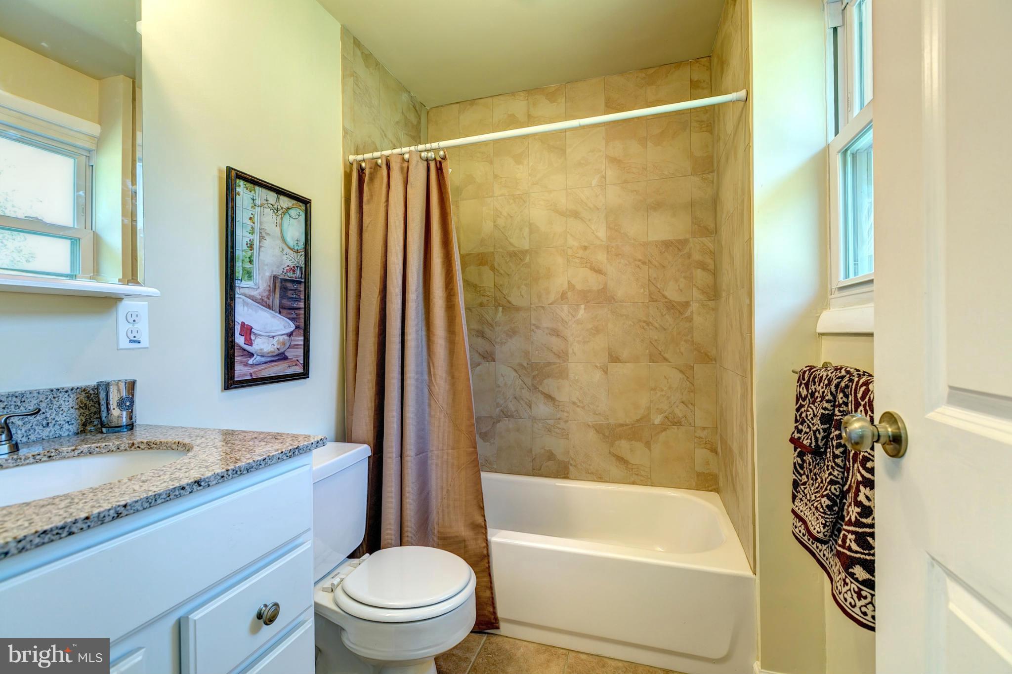 6711 Fox Meadow Road Baltimore, MD 21207 - Photo 16 of 30 a bathroom with a granite countertop sink toilet and shower