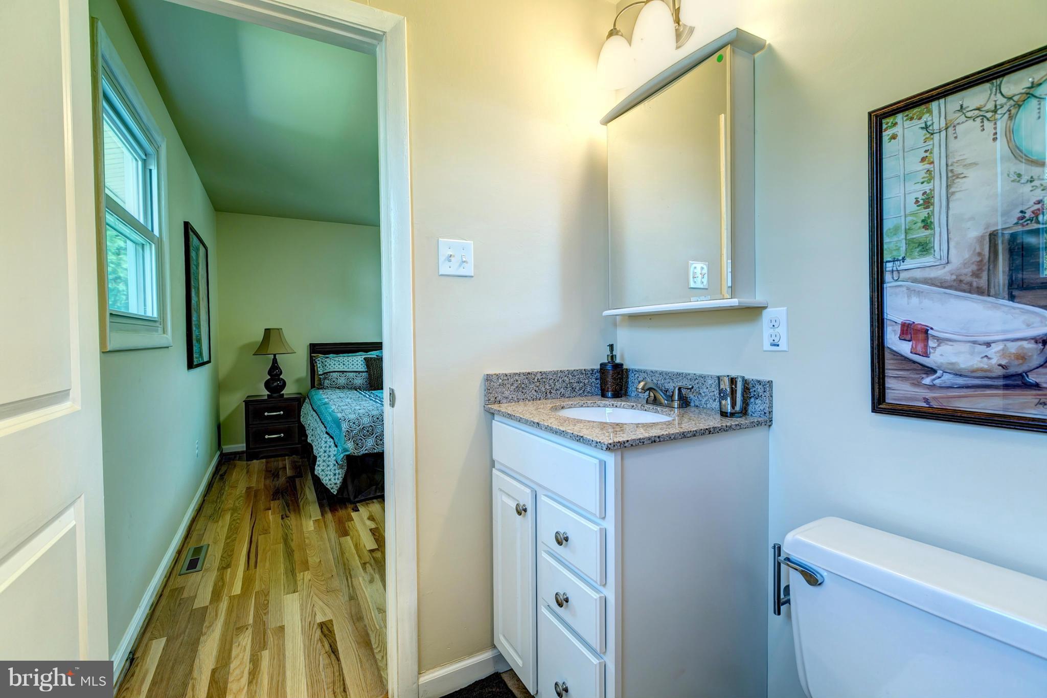 6711 Fox Meadow Road Baltimore, MD 21207 - Photo 17 of 30 a bathroom with a sink and a mirror
