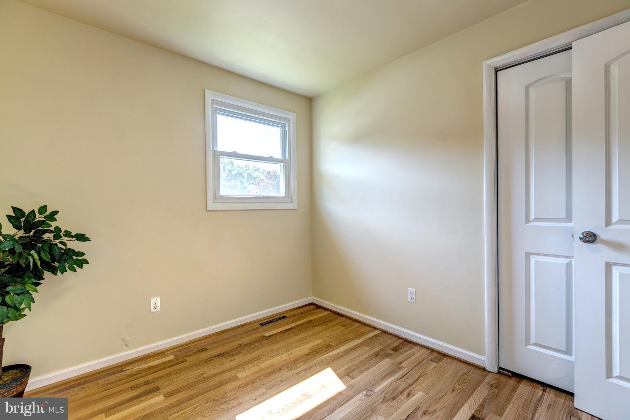 6711 Fox Meadow Road Baltimore, MD 21207 - Photo 19 of 30 an empty room with wooden floor and closet