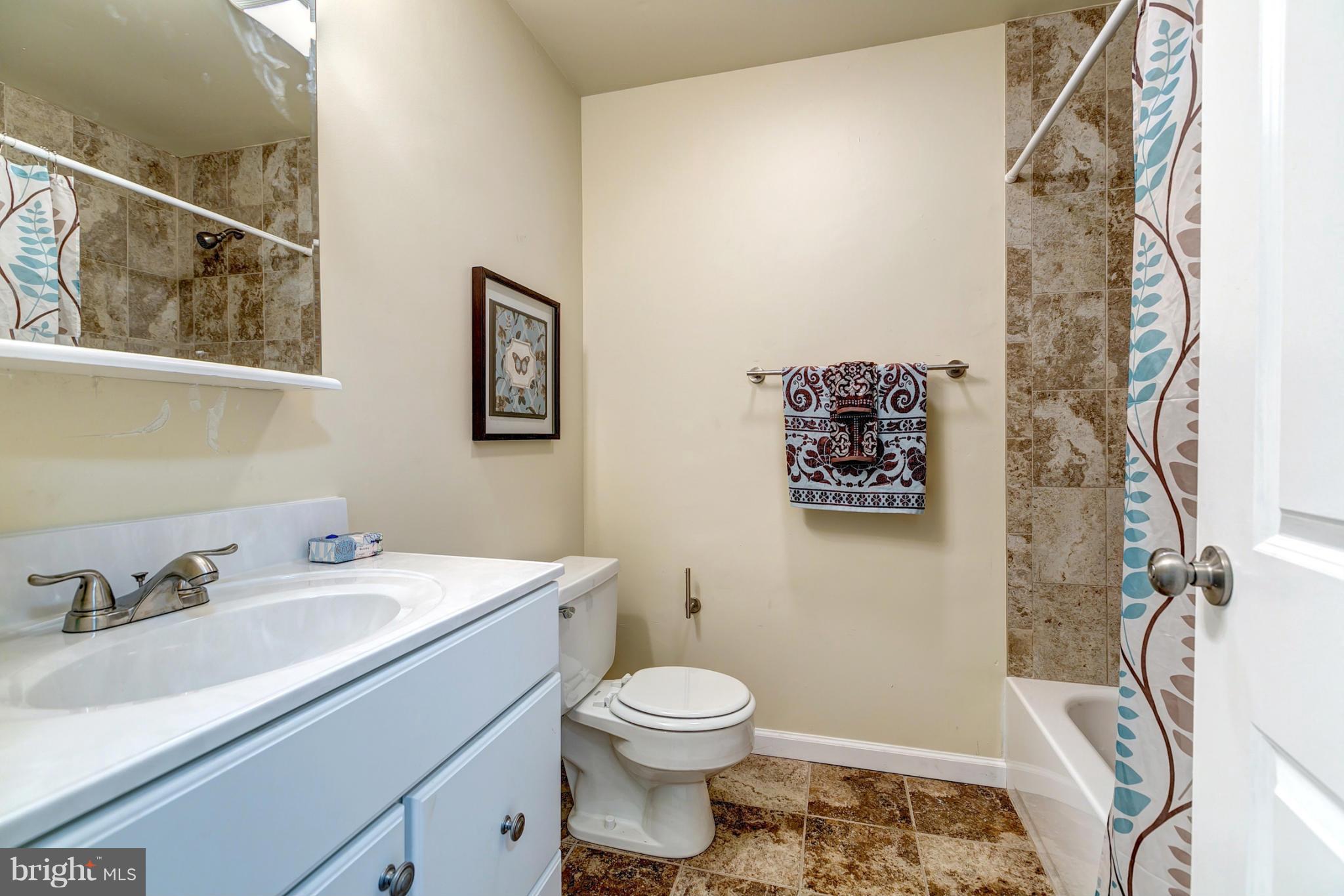 6711 Fox Meadow Road Baltimore, MD 21207 - Photo 20 of 30 a bathroom with a sink toilet and vanity