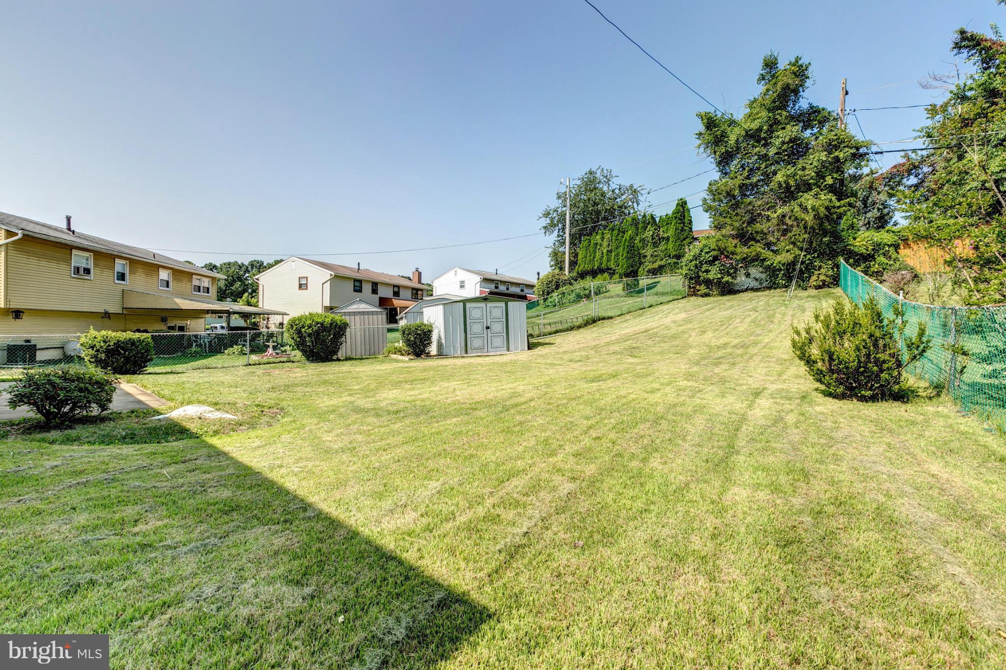 6711 Fox Meadow Road Baltimore, MD 21207 - Photo 27 of 30 a swimming pool with plants and large trees
