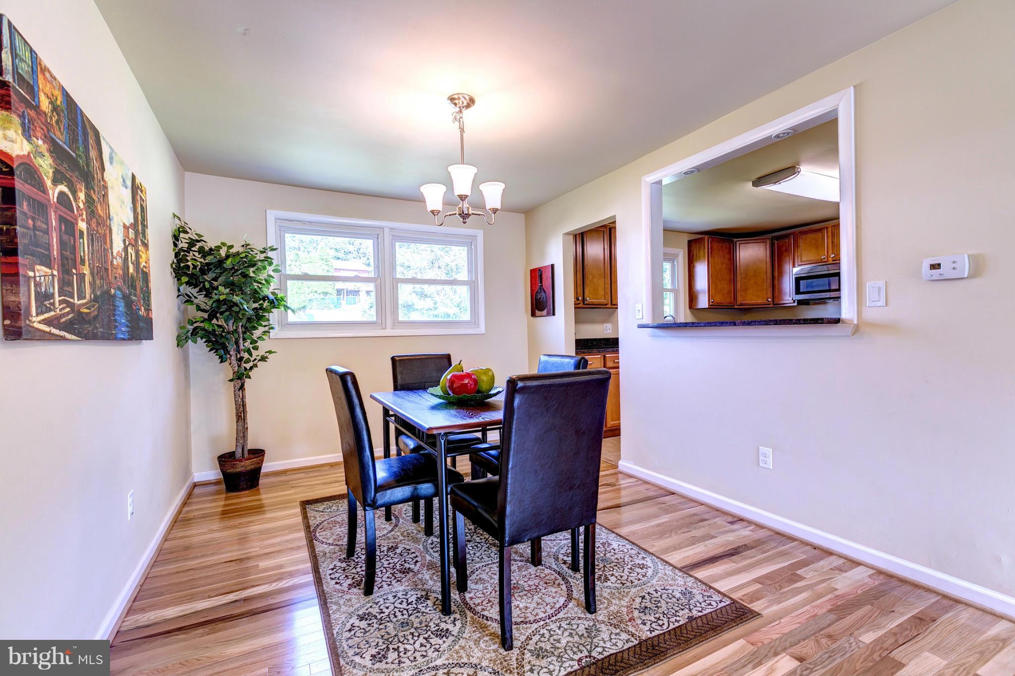 6711 Fox Meadow Road Baltimore, MD 21207 - Photo 6 of 30 a view of a dining room with furniture window and wooden floor