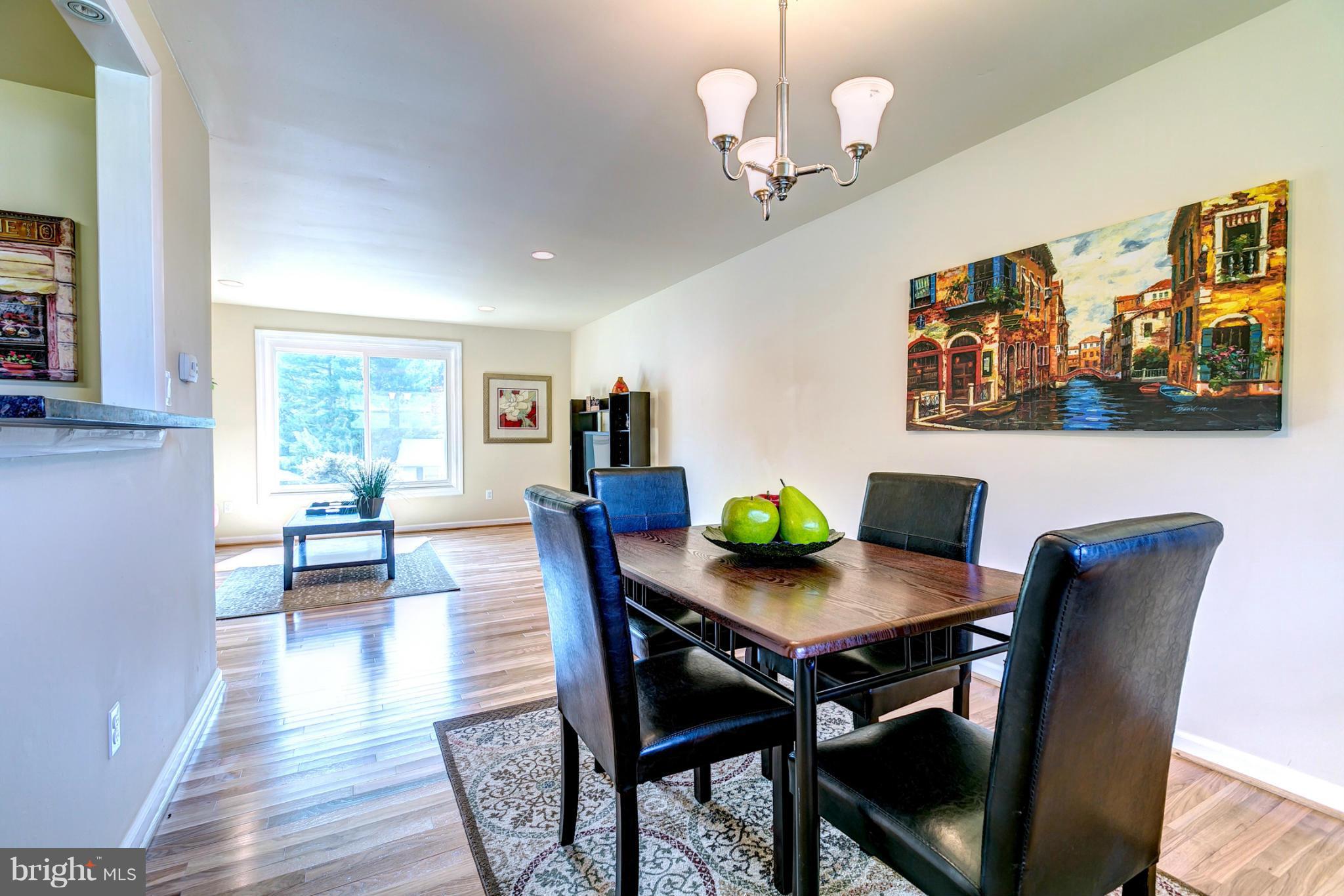 6711 Fox Meadow Road Baltimore, MD 21207 - Photo 7 of 30 a view of a dining room with furniture window and wooden floor