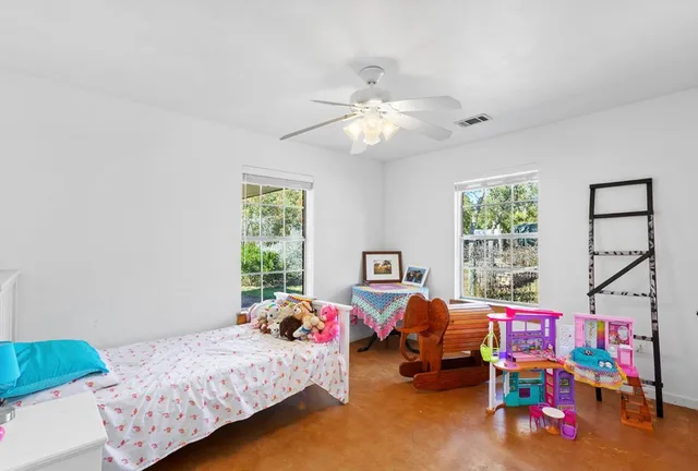 a living room with furniture and a book shelf
