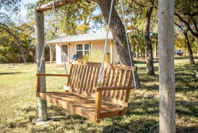 a view of a backyard with wooden fence