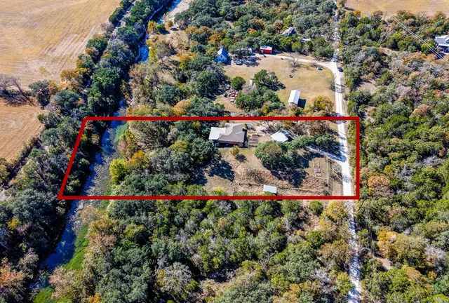an aerial view of residential houses with outdoor space