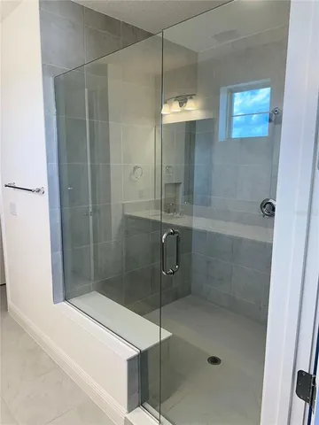 a bathroom with a shower and a sink