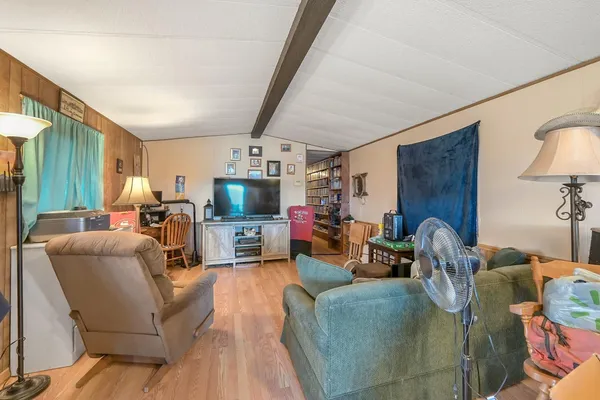 a living room with furniture a fireplace and a flat screen tv