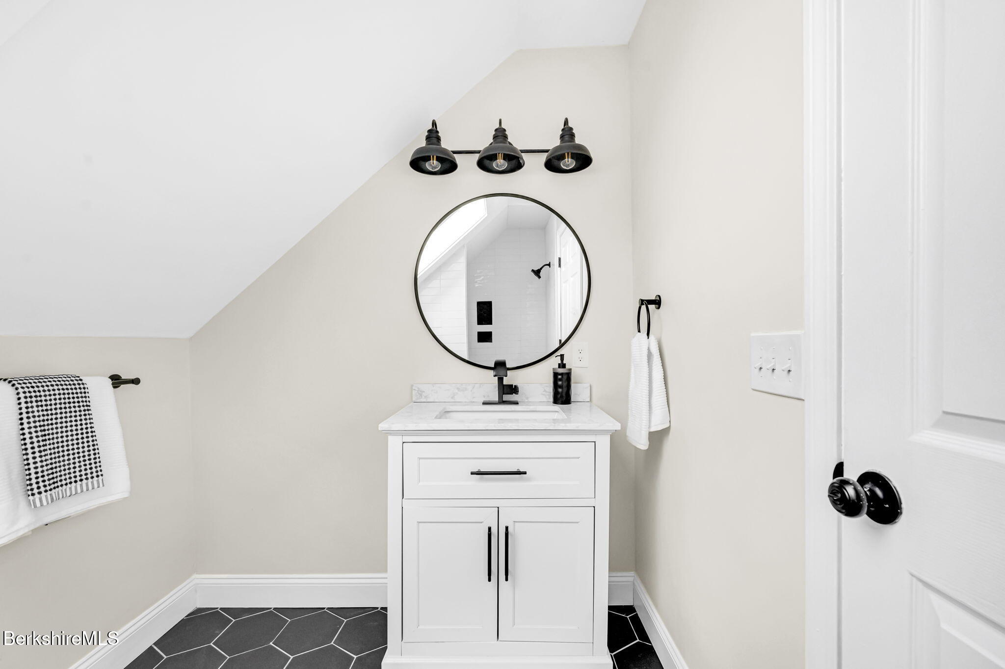 11 E Road Richmond, MA 01254 - Photo 40 of 65 a bathroom with a sink a toilet and mirror