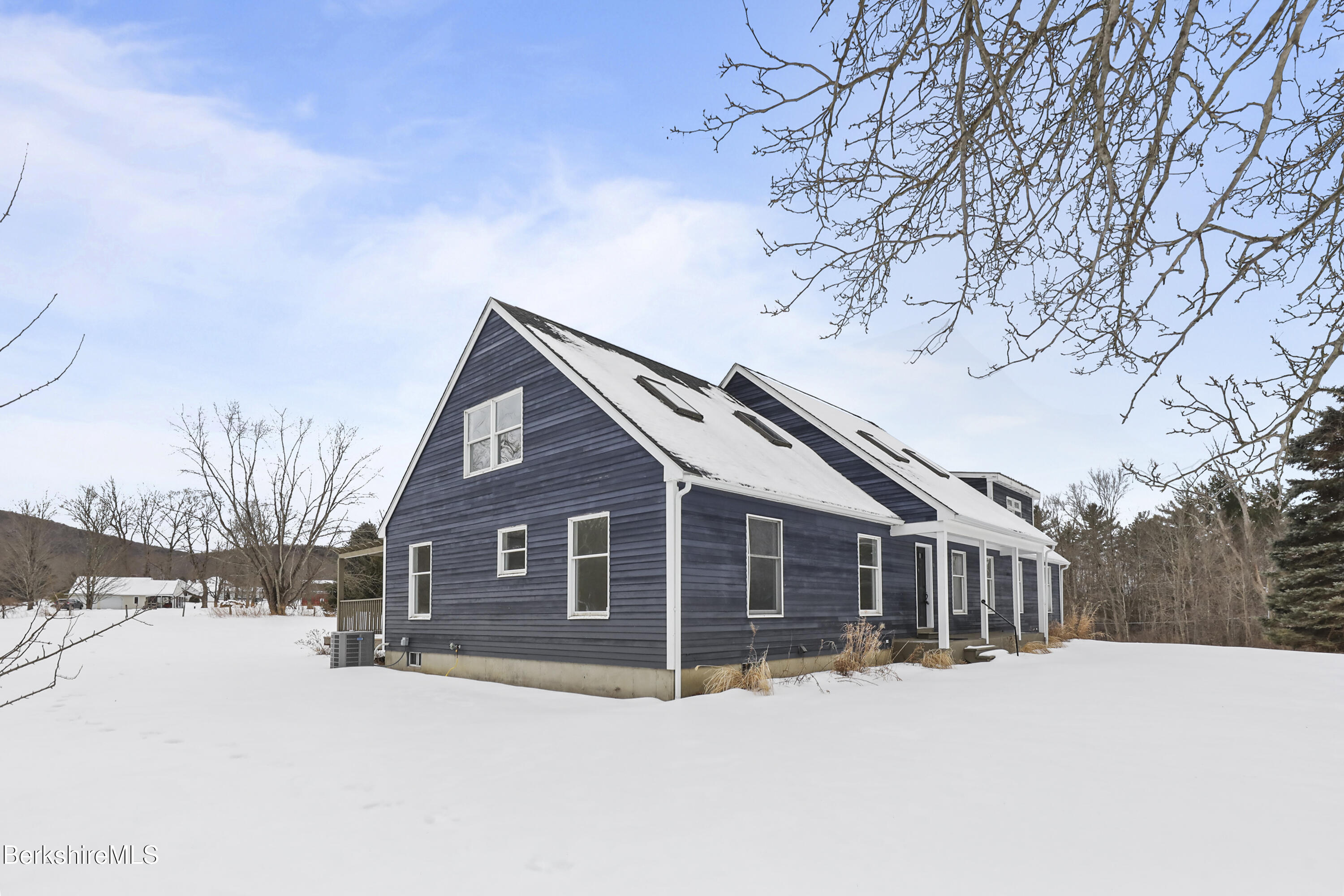 11 E Road Richmond, MA 01254 - Photo 3 of 65 a front view of a house with a yard covered in snow