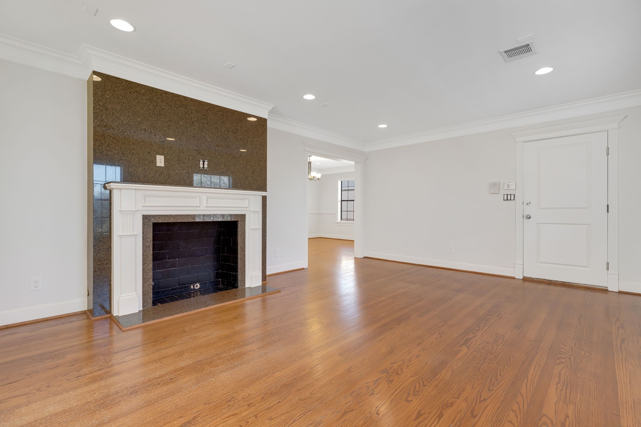 2306 Blodgett Street, Unit 2 Houston, TX 77004 - Photo 2 of 12 a view of an empty room with wooden floor fireplace and a window
