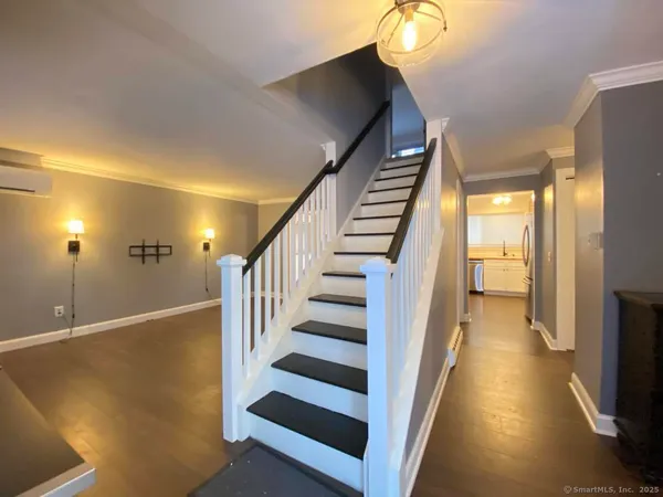 a view of entryway and hall with wooden floor