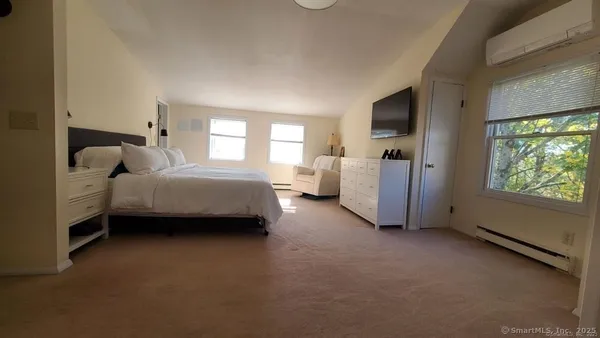 a bed room with a bed and a large window