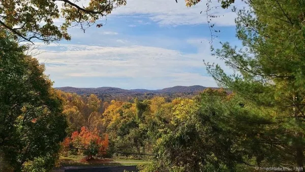 a view of balcony with wooden floor and outdoor seating