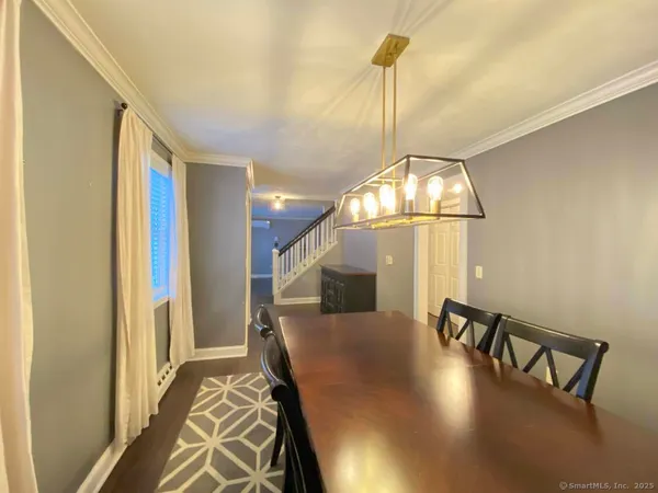 a view of a livingroom with furniture wooden floor and a chandelier