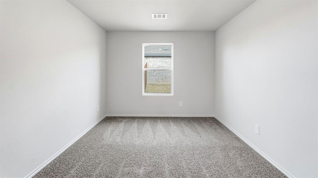 3535 Spring Time Street Forney, TX 75126 - Photo 13 of 23 Room featuring light gray wall paint, gray patterned carpet, white baseboards, a white-framed window, and recessed ceiling lighting