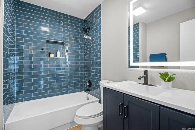 a bathroom with a sink a toilet and bathtub