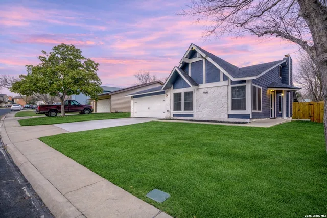 a front view of a house with a garden and deck