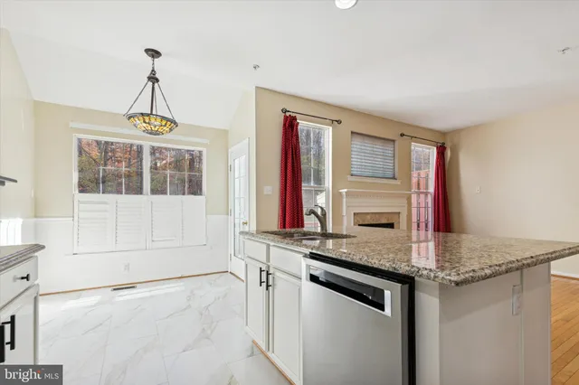 a kitchen with stainless steel appliances granite countertop a stove and a sink