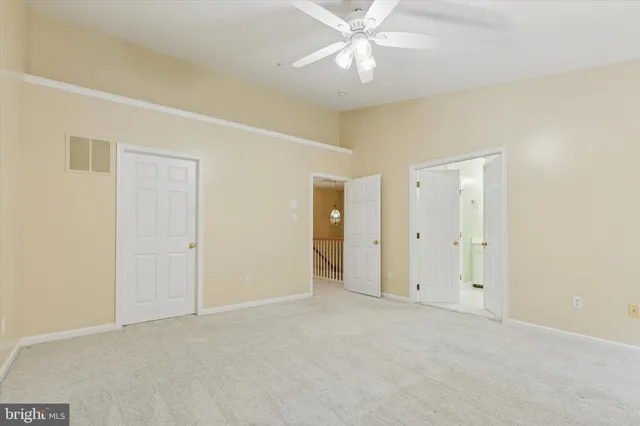 a view of an empty room with a fan