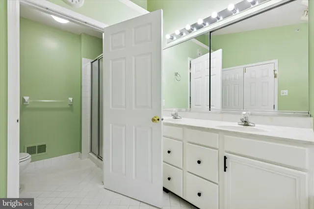 a bathroom with a double vanity sink and mirror
