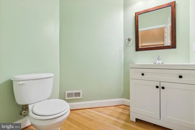 a white toilet sitting next to a bathroom sink