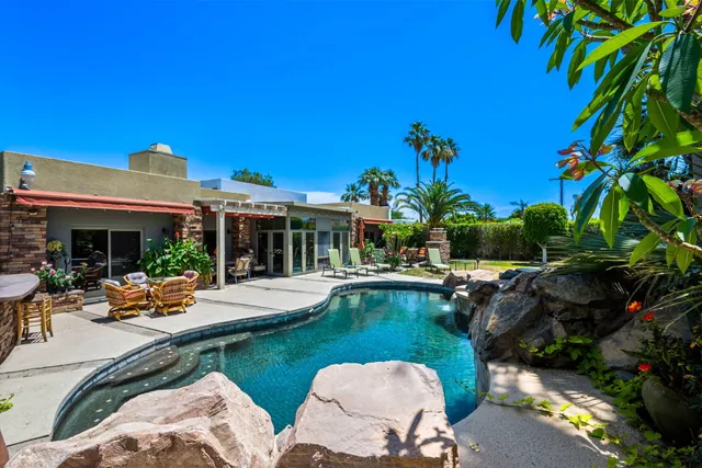 a view of a backyard with plants and patio