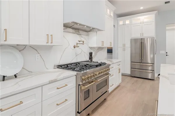 a kitchen with a stove and a refrigerator