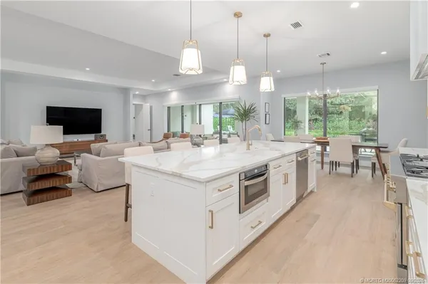 a large white kitchen with a large window