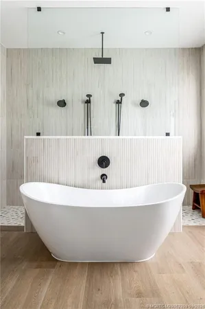 a white tub sitting next to a window