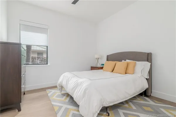 a bedroom with a bed and mirror
