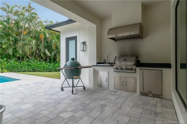 a view of a house with a swimming pool and sitting area