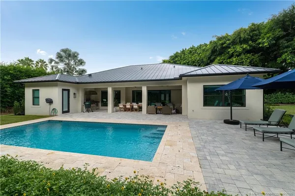 a view of a house with pool porch and chairs